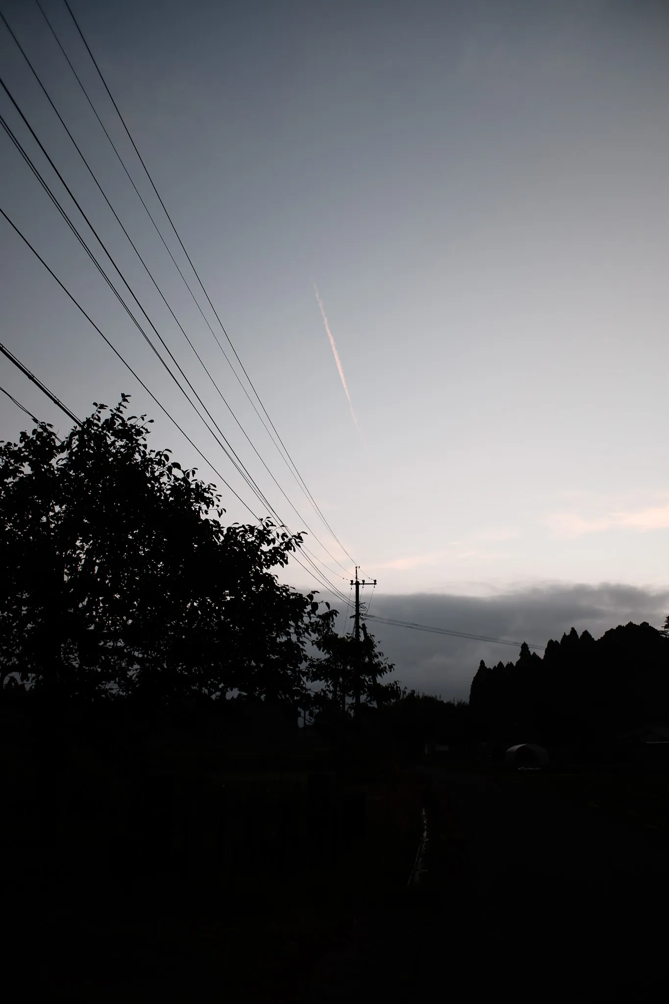 Dusk sky and power lines above the road to the cottage